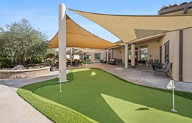 A large umbrella is covering a putting green, providing shade for people playing golf. AI generated content
